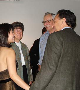 Yumi and her husband Daniel Williams speak with patrons backstage after a performance